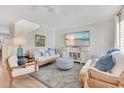 Bright living room featuring hardwood floors, stylish seating, and a coastal-themed TV display at 5238 Baskin St, Orlando, FL 32814