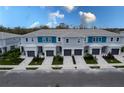 Aerial view of townhomes showcasing similar exteriors, paved driveways, and manicured lawns at 7838 Spectrum Dr, Kissimmee, FL 34747