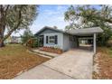 Single story home with covered parking and a well-maintained front yard at 103 Brown Dr, Sanford, FL 32773