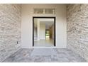 Spacious entryway with stone walls leading into a home with natural light at 10912 Mobberley Cir, Orlando, FL 32832