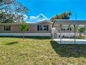 Charming single-story home showcasing a carport, landscaped front yard, and light beige vinyl siding at 1510 Oak Ln, Casselberry, FL 32707
