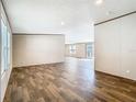 Spacious living room featuring wood-look flooring, neutral walls, and ample natural light at 1510 Oak Ln, Casselberry, FL 32707