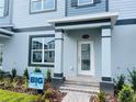 Close-up of a townhome entrance showing stylish details and landscaping, enhancing curb appeal at 15352 Burgtheater Dr, Winter Garden, FL 34787