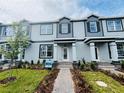 Inviting light blue townhome showcasing neat landscaping, a brick walkway, and a charming exterior at 15352 Burgtheater Dr, Winter Garden, FL 34787