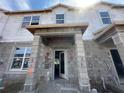 Image showing the exterior of a townhome in construction, with block and Tyvek wrap at 15352 Burgtheater Dr, Winter Garden, FL 34787