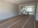 Open-concept living space with tile flooring leading to a modern kitchen at 15352 Burgtheater Dr, Winter Garden, FL 34787