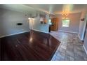The open-concept living space features dark wood floors that flow into a tile kitchen with bar seating at 1703 Doreen Ave, Ocoee, FL 34761