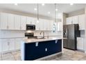 Open kitchen featuring a center island, stainless steel appliances, and white cabinets at 1711 Lake Sims Pkwy, Ocoee, FL 34761