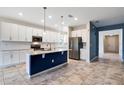 Spacious kitchen featuring a center island with a sink, stainless steel appliances, and white cabinets at 1711 Lake Sims Pkwy, Ocoee, FL 34761