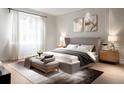 Serene bedroom with soft colors, a king-size bed, light wood floors, decorative artwork, and natural light from large windows at 1917 Geigel Ave, Orlando, FL 32806