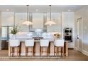 Bright, modern kitchen with a large island, stylish pendant lighting, and stainless steel appliances at 2102 S Osceola Ave, Orlando, FL 32806