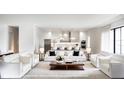 Open-concept living room featuring modern white sofas, a fireplace and connecting to the kitchen at 2102 S Osceola Ave, Orlando, FL 32806