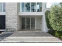 Detailed view of the entryway, highlighting the modern door, stone facade, and the sleek, minimalist design at 229 Alexander Pl, Winter Park, FL 32789