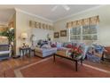 Cozy living room with plush sofa, natural light, and warm decor at 25221 Quail Croft Pl, Leesburg, FL 34748