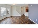 Bright living room with tile floors, staircase, and view of the open-concept kitchen at 2604 Grand Central Pkwy # 12, Orlando, FL 32839