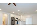 Modern kitchen featuring white cabinetry, stainless steel appliances, and granite countertops at 2765 Sw 140Th Pl, Ocala, FL 34473
