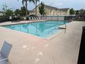 Sparkling community pool with lounge chairs, perfect for relaxing and enjoying the Florida sunshine at 2836 Club Cortile Cir, Kissimmee, FL 34746