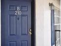 Condo front door in blue with gold hardware and white trim, house number B210 at 3651 N Goldenrod Rd # 210, Winter Park, FL 32792