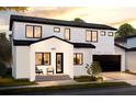 Modern two-story home with white stucco, black trim, and a cozy covered front porch entry at 405 Calhoun Pl, Orlando, FL 32801