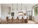 Modern kitchen with a large island, stainless steel appliances, and sleek white cabinetry at 405 Calhoun Pl, Orlando, FL 32801