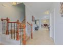 Bright foyer with staircase, wood railings, and tile flooring, leading to the dining and living areas at 410 Hudson St, Orlando, FL 32835