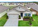 Inviting single-story home with a spacious driveway, manicured lawn, and charming blue shutters at 432 Tallow Wood Cir, Debary, FL 32713