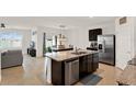 Open kitchen featuring a granite island, stainless steel appliances, and a view to the dining area at 432 Tallow Wood Cir, Debary, FL 32713