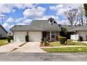 Street view of multiple single story homes with attached garages and well-maintained front lawns at 4516 Summergrove Ave, Orlando, FL 32812