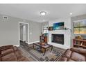 Cozy living room with a white brick fireplace and dark wood-look flooring at 4521 Jim Glenn Dr, Orlando, FL 32808