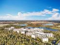 Beautiful aerial view of the resort surrounded by lush greenery and serene lakes, showing the expansive property and natural beauty at 14501 Grove Resort Grove Resort Ave # 3733, Winter Garden, FL 34787