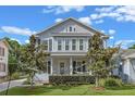 Charming two-story home with manicured front lawn, landscaping and colorful prayer flags at 149 E Muriel St, Orlando, FL 32806