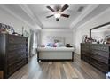 Spacious main bedroom featuring a tray ceiling, dark wood furniture, and a large upholstered bed at 149 E Muriel St, Orlando, FL 32806