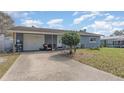 Charming single-story home showing driveway, well-manicured lawn, and an attached garage on a bright, sunny day at 1503 Wisconsin Ave, St Cloud, FL 34769