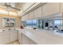 Bright kitchen with spacious countertops and ocean view access to living room at 1575 Ocean Shore Blvd # 306, Ormond Beach, FL 32176