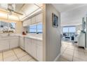 Well-lit kitchen featuring tiled floors, white countertops, and ocean views at 1575 Ocean Shore Blvd # 306, Ormond Beach, FL 32176