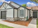 The front exterior is a modern design with stacked stone and a dark painted front door at 2229 Churchill Downs Cir, Orlando, FL 32825