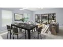 Stylish dining room with a dark wood table set for six, bathed in natural light from surrounding windows at 3575 Victoria Pines Dr # 276, Orlando, FL 32829