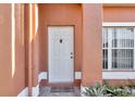 Close-up of the entryway showing the front door and decorative landscaping around the house at 372 Aylesbury Ct, Kissimmee, FL 34758