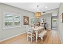 Bright dining room with wood floors and a decorative light fixture above the table at 4216 Kildaire Ave, Orlando, FL 32812