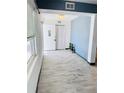 A bright entryway features wood-look tile flooring, fresh paint and modern light fixture at 423 Ololu Dr, Winter Park, FL 32789