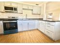 This kitchen features tile floors, granite counters and stainless steel appliances at 430 Pennsylvania Ave, Winter Garden, FL 34787