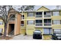 Inviting multi-level condo building featuring garages, balconies, and convenient stair access at 5017 City St # 1932, Orlando, FL 32839