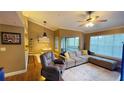 Spacious living room featuring hardwood floors, a ceiling fan, and balcony access with natural lighting at 5017 City St # 1932, Orlando, FL 32839