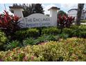 Entrance sign for 'The Enclaves Amenity Center' surrounded by vibrant landscaping and colorful foliage at 510 Captiva Dr, Davenport, FL 33896