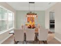 Dining room boasting abundant natural light, hardwood floors, and stylish furnishings at 565 Big Pine Ave, Minneola, FL 34715