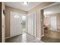 Bright entryway featuring wood-look flooring and a view into the dining area at 620 Wexford Ct, Winter Haven, FL 33884