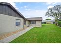 Cozy home exterior featuring well-kept lawn and a walkway leading to the entrance at 620 Wexford Ct, Winter Haven, FL 33884