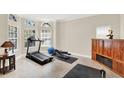 Bright exercise room with natural light, tile flooring, and workout equipment at 6992 Brescia Way, Orlando, FL 32819