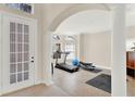 Bright exercise room with natural light, tile flooring, and workout equipment at 6992 Brescia Way, Orlando, FL 32819