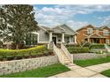 Charming single-story home with manicured lawn and stone accents, showcasing curb appeal and inviting entrance at 707 Brandy Oaks Loop, Winter Garden, FL 34787